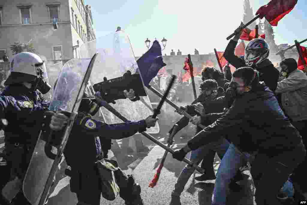 Students clash with riot police in front of the Greek Parliament during a demonstration against the government&#39;s plans for private universities, in Athens.