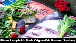 Flowers are placed next to a portrait of Russian opposition leader Alexey Navalny in front of the Russian embassy in Copenhagen, Denmark, Feb. 16, 2024. (Ritzau Scanpix/Ida Marie Odgaard)