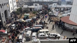 Displaced Palestinians gather in the yard of Gaza's Al Shifa hospital, Dec. 10, 2023.