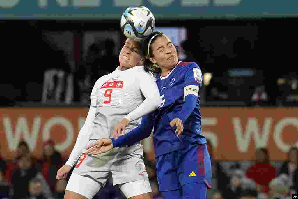 Switzerland's Ana Maria Crnogorcevic, left, heads the ball next to Philippines' Hali Long during the second half of the Women's World Cup Group A soccer match between the Philippines and Switzerland in Dunedin, New Zealand.