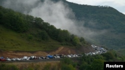 (FILE) Vehicles carrying refugees from Nagorno-Karabakh.