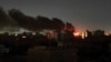 FILE - Smoke rises over the horizon as a fire burns after a strike in Khartoum, Sudan, April 16, 2023.