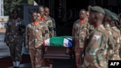 FILE—Members of the South African National Defence Forces carry a coffin during the funeral for two of its soldiers at the Waterkloof Air Force Base, on February 21, 2024. The two were killed in a mortar strike that landed near a SANDF base in Sake, DRC, on February 14, 2024. 