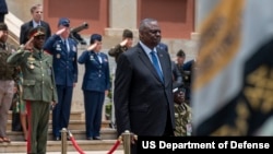 Secretary of Defense Lloyd J. Austin III stands during the playing of the Angola national anthem in Luanda, Angola, Sept. 27, 2023.