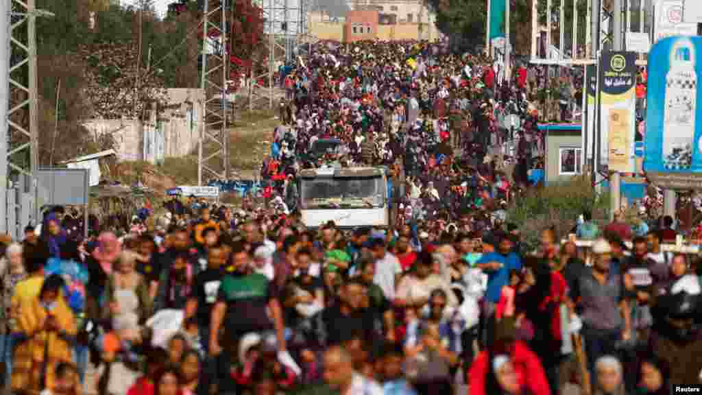 Palestinians fleeing north Gaza move southward as Israeli tanks roll deeper into the enclave, amid the ongoing conflict between Israel and Hamas, in the central Gaza Strip.