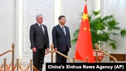 FILE - Cuba's President Miguel Diaz-Canel Bermudez, left, and Chinese President Xi Jinping stand during a welcome ceremony at the Great Hall of the People in Beijing, Nov. 25, 2022. 