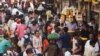 FILE - People walk through a crowded market in Mumbai, India, Dec. 22, 2022. 