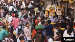 FILE - People walk through a crowded market in Mumbai, India, Dec. 22, 2022. 