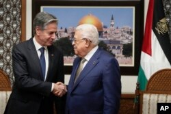 FILE—U.S. Secretary of State Antony Blinken, left, and Palestinian President Mahmoud Abbas shake hands during their meeting in the West Bank town of Ramallah, February 7, 2024.