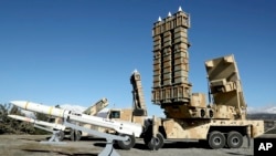 In this image released by the Iranian Defense Ministry on Feb. 17, 2024, the domestically built Arman air defense system, right, is displayed during its unveiling with Sayyad-3 missiles, left, at an undisclosed location in Iran.