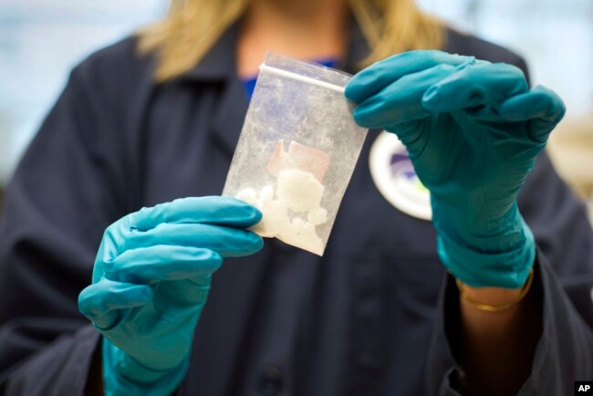 FILE - A bag of 4-fluoro isobutyryl fentanyl that was seized in a drug raid is displayed at the Drug Enforcement Administration Special Testing and Research Laboratory in Sterling, Va., Aug. 9, 2016.