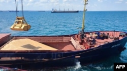 FILE - Grain is loaded aboard a cargo ship at the Azov Sea Port, Rostov region, on July 22, 2023.