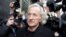 FILE - Journalist John Pilger, who was a supporter of Wikileaks founder Julian Assange, arrives at the City of Westminster Magistrates Court in London where Assange was in court for a bail hearing, Dec. 14, 2010. Pilger died Saturday at 84.