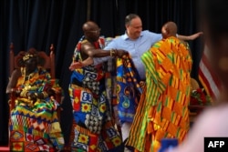 Second Gentleman Douglas Emhoff receives a traditional Kente cloth while Chief Osabarima Kwesi Atta II (L) looks on at the Emintsimadze Palace in Cape Coast, Ghana, on March 28, 2023.
