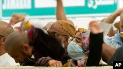 Muslim pilgrims cast stones at pillars in the symbolic stoning of the devil, the last rite of the annual Hajj, in Mina near the holy city of Mecca, Saudi Arabia, June 30, 2023. 