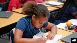 Aaliyah Ibarra works on her memory book during the last week of classes at Frye Elementary School in Chandler, Arizona, May 23, 2023. 