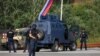Kosovo police and US and EU troops stand by after one police officer was killed, another hurt in Kosovo gunfire, in Josevik, Kosovo, Sept. 24, 2023. 