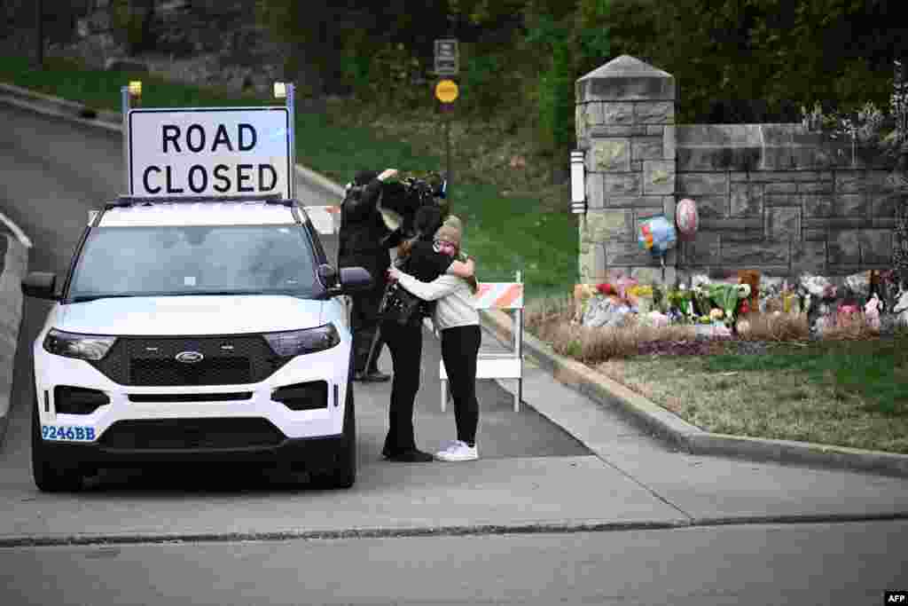 A woman hugs a police officer at the entrance of the Covenant School at the Covenant Presbyterian Church, in Nashville, Tennessee.&nbsp;A heavily armed former student killed three young children and three staff in what appeared to be a carefully planned attack at a private elementary school in Nashville, before being shot dead by police.