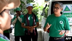 In this photo taken on July 4, 2023, Yeng Virak (R), president of Cambodia's Grassroots Democratic Party (GDP) speaks to members of his party during the general election campaign in Phnom Penh.