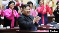FILE - North Korea's leader Kim Jong Un applauds at the 5th National Meeting of Mothers in Pyongyang in this picture released by the Korean Central News Agency on Dec. 4, 2023. (KCNA via Reuters)
