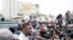 FILE: Ousmane Sonko speaks to reporters as his convoy stops on the way to his trial in Dakar on March 16, 2023. -