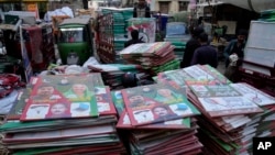 Workers load posters of election candidates from a political party into a van at their workshop ahead of Feb. 8 general elections in Lahore, Pakistan, Feb. 2, 2024. 