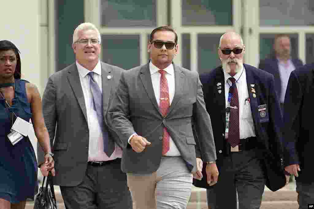 U.S. Rep. George Santos, center, with his attorney Joseph Murray, second from left, depart federal court with security and journalists in tow, in Central Islip, New York. Santos returned to court Friday for the first time since pleading not guilty last month to charges that he duped donors, stole from his campaign, collected fraudulent unemployment benefits and lied to Congress about being a millionaire.