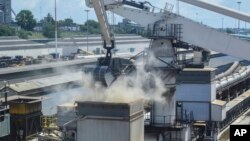 FILE - Grain is offloaded from the Eaubonne bulk carrier ship after it docked in the port of Mombasa, Kenya, Nov. 26, 2022. 