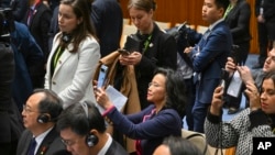 Chinese-born Australian journalist Cheng Lei, center, films a signing ceremony with Chinese Premier Li Qiang and Australian Prime Minister Anthony Albanese at Parliament House in Canberra, June 17, 2024. 