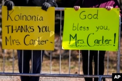 People watch the motorcade as it moves to Maranatha Baptist Church where the funeral service for former first lady Rosalynn Carter was held, in Plains, Georgia, Nov. 29, 2023.