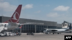 FILE - Airplanes are parked at Aden Adde International Airport in Mogadishu, Somalia, on Feb. 13, 2022. A passenger plane crash-landed at the airport on July 11, 2023.