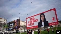 FILE - Birds fly above election campaign billboards for leftist parties in Lisbon, Feb. 24, 2024. The official two-week campaign period before Portugal's snap general election begins Feb. 25, 2024.