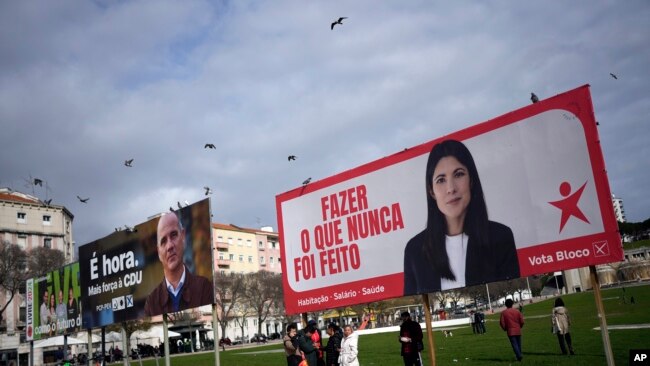 FILE - Birds fly above election campaign billboards for leftist parties in Lisbon, Feb. 24, 2024. The official two-week campaign period before Portugal's snap general election begins Feb. 25, 2024.