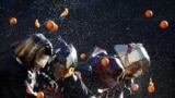 Revelers take part in a fight with oranges during an annual carnival battle in Ivrea, Italy, Feb. 11, 2024.