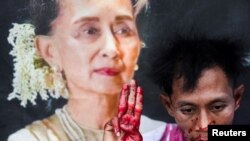 A protester with fake blood on his body raises a three-finger salute in a demonstration to mark the third anniversary of Myanmar&rsquo;s 2021 military coup, outside of the United Nations office in Bangkok, Thailand.