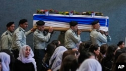 Israeli soldiers carry the flag-draped coffin of Druze Israeli Lt. Col. Salman Habaka in the village of Yanuh Jat, northern Israel, Nov. 3, 2023.