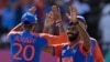 India's Jasprit Bumrah, right, celebrates with teammate Axar Patel after the dismissal of England's Phil Salt during the ICC Men's T20 World Cup second semifinal cricket match in Providence, Guyana, June 27, 2024.