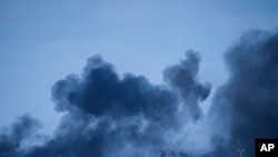 FILE - Smoke rises following an Israeli bombardment in the Gaza Strip, as seen from southern Israel on Tuesday, January 30, 2024.