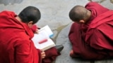 (FILE) Tibetan monks chant as they study prayer books at Nanmo monastery in Kangding county.