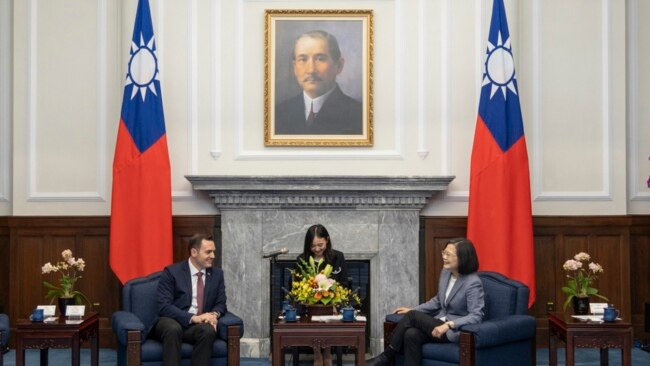 In this photo released by the Taiwan Presidential Office, Taiwan's President Tsai Ing-wen, right, talks to US Rep. Mike Gallagher on the Chinese Communist Party, left, in Taipei, Taiwan, Feb. 22, 2024.