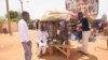 Men stand in a street side market in Niamey, Niger, July 29, 2023. 
