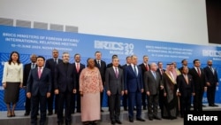 FILE - Officials pose for a group photo during a meeting of the BRICS Plus Ministerial Council in the city of Nizhny Novgorod, Russia, June 11, 2024.