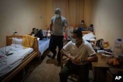 Wounded Colombian veterans who joined Ukrainian armed forces to help the country fight Russia receive treatment in a hospital in Ukraine, Dec. 20, 2023.