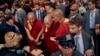 The Dalai Lama, center, arrives at Park Hyatt hotel as supporters greet him, in New York, June 23, 2024. 