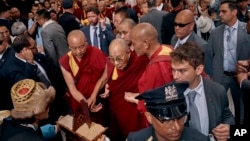 The Dalai Lama, center, arrives at Park Hyatt hotel as supporters greet him, in New York, June 23, 2024. 