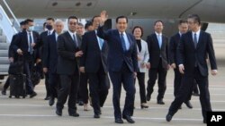 Former Taiwan President Ma Ying-jeou, center, waves as he arrivers with his delegation at the Pudong airport in Shanghai, China, March 27, 2023, in this photo released by Ma Ying-jeou Office.