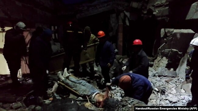 This grab from footage released by the Russian Emergencies Ministry on Feb. 3, 2024, shows rescuers removing victims and searching for survivors inside a bakehouse hit by shelling in Lysychansk. AFP PHOTO / Russian Emergencies Ministry