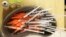 FILE - Syringes with COVID-19 vaccine sit ready for use in New Orleans, Jan. 25, 2022. COVID-19 hospital admissions have inched upward in the U.S. since early July; an updated vaccine is still months away.