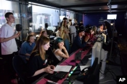 FILE - Journalists work in a news room of the Dozhd (Rain) TV channel in Moscow, Russia, Aug. 20, 2021.