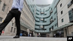 FILE - A view of the main entrance to the headquarters of the publicly funded BBC in London, July 19, 2017. Senior British politicians called on the BBC, July 9, 2023, to rapidly investigate a complaint that a leading presenter paid a teenager for explicit photos. 